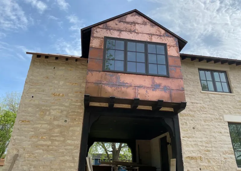 Copper metal panel facade on a stone building for Metal Roof Coating in Tulsa