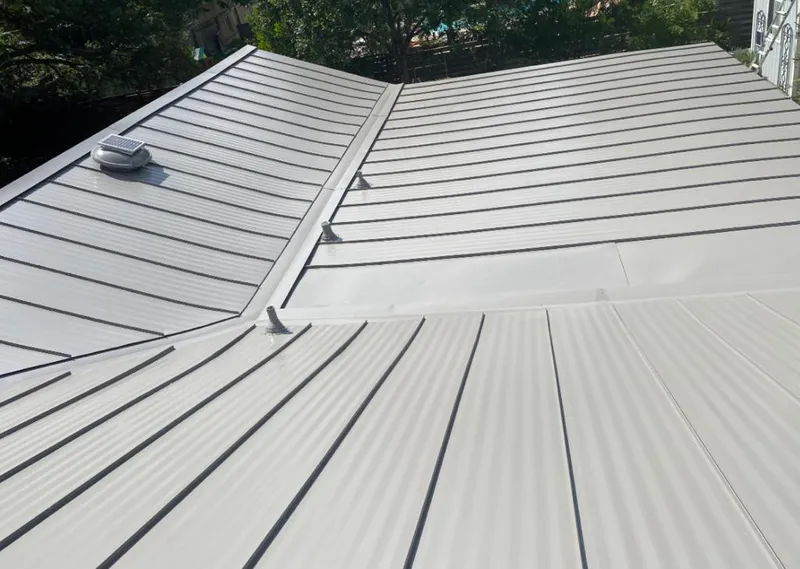 Solar attic fan installed on a metal roof for Roof Ventilation in Tulsa